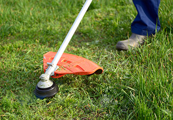An electric string strimmer used to take some grass off harder to reach places a mower can struggle with